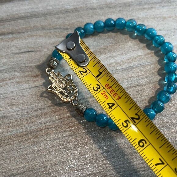 Light Blue Bead Stretch Bracelet with Gold Tone Hamza Hand - Picture 7 of 7